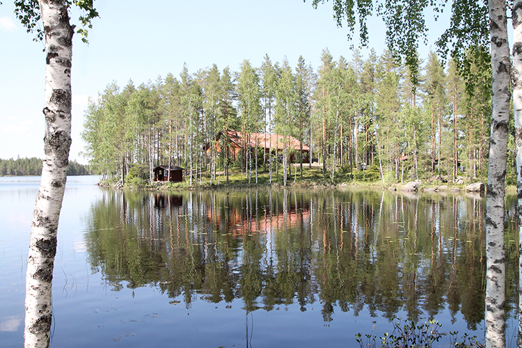 Louetin leirimajan päärakennus järven yli kuvattuna